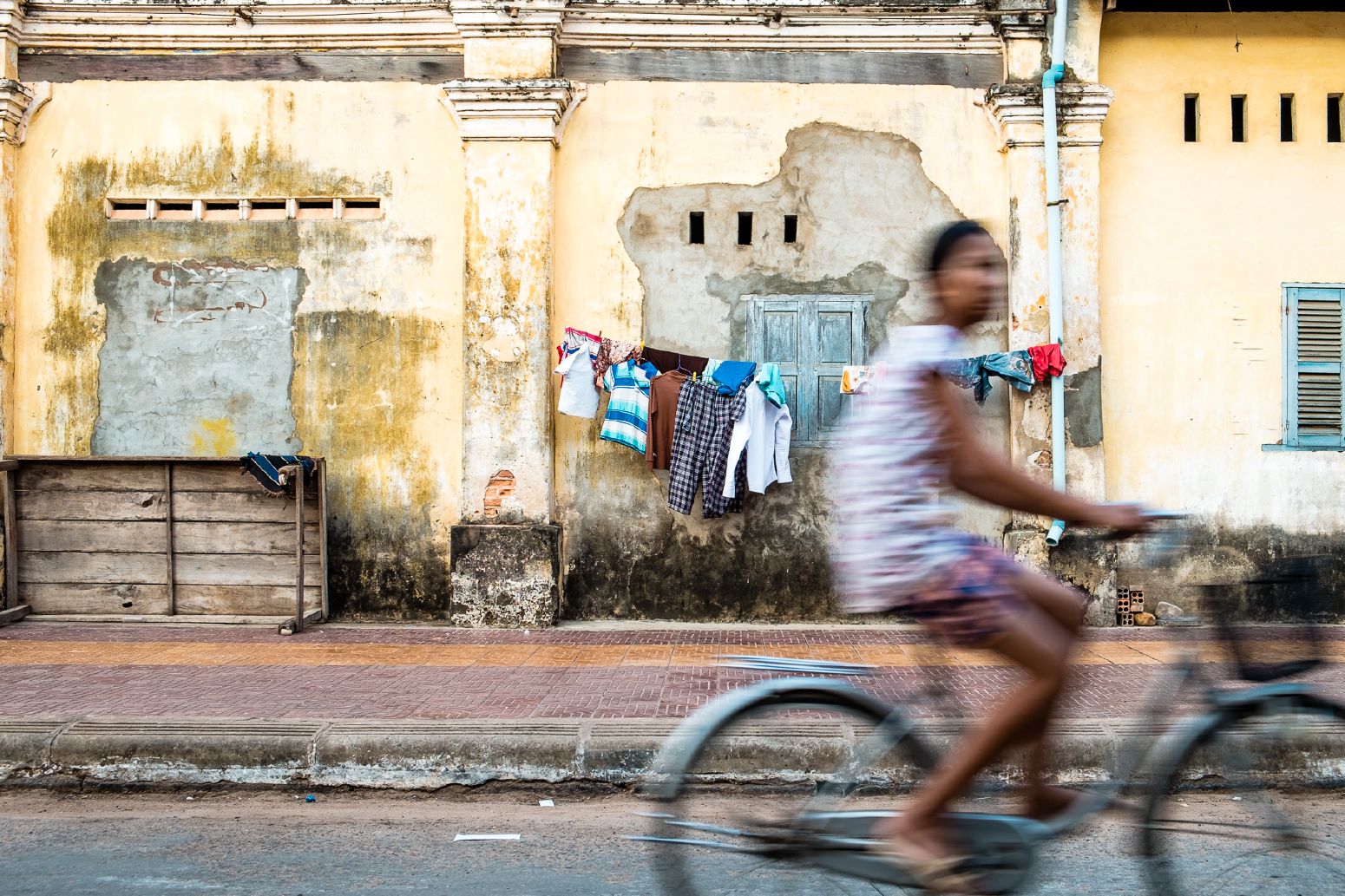 Girl on a bike in Kampot. Kampot, Cambodia. March 2014